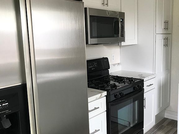 New cabinets, new quartz countertops, new tile plank flooring & new microwave .