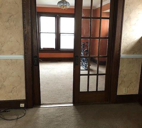 Living room going into Dining Room. There are 2 sliding doors, 1 door is stuck.