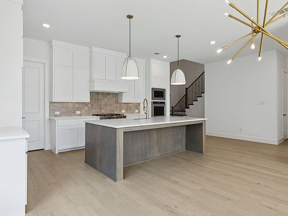Kitchen in the Weston II Floorplan at Windsong Ranch 61 s in Prosper, TX.