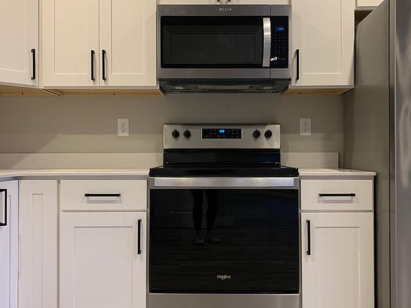 new stainless steels appliances, soft shut cabinets, and quartz countertops