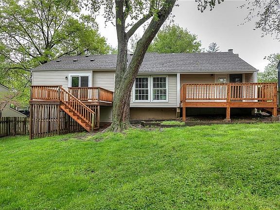 The back of the home.  It has 2 new decks. One from the dining room,  the other one is leading from the master bedroom.