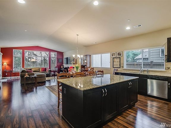 This grand space is perfect for large gatherings of friends and family. The gourmet kitchen features a huge island, quiet-close cabinets and more. Enjoy the wall of windows overlooking the landscape.