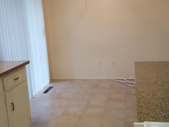 Kitchen dining area. Valance has been removed; kitchen cabi