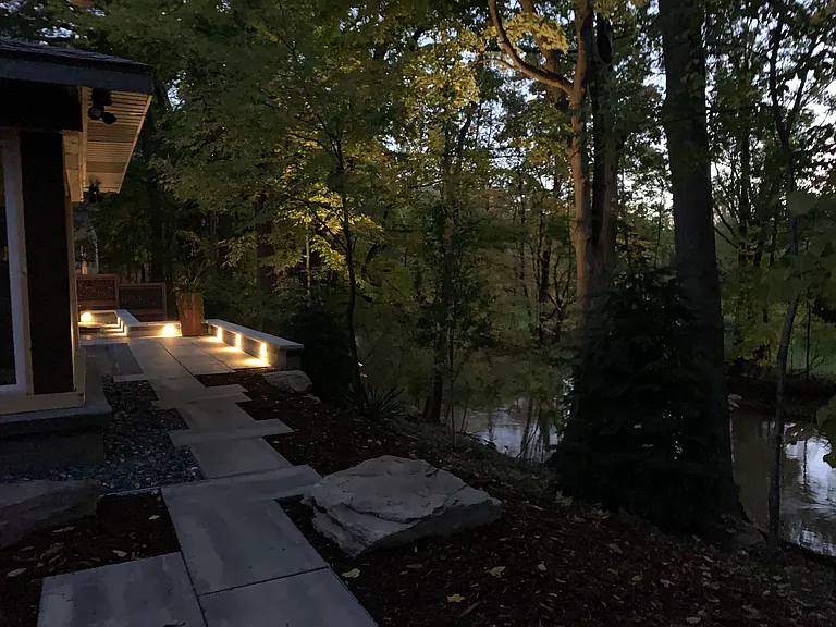 patio lighting at night with uplighting on trees