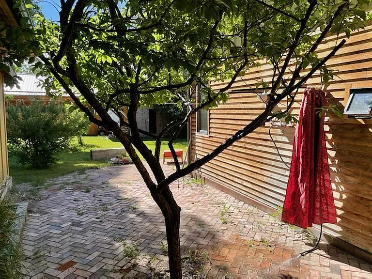 Outdoor shower with yard in background.