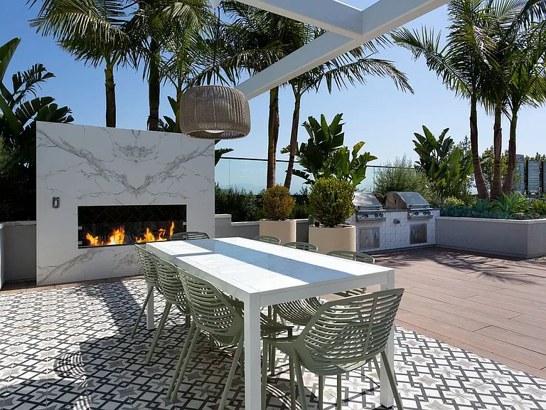 Building A rooftop lounge with fireplace, grills and seating