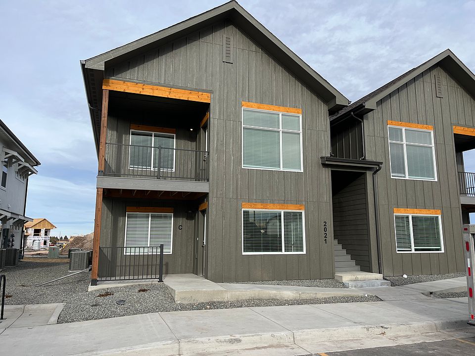 Upper unit with balcony and larger living room windows.