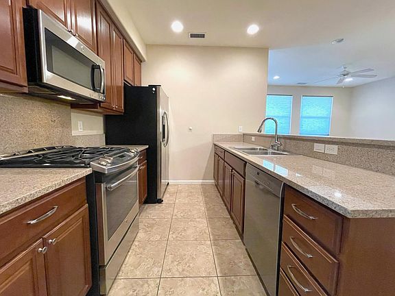 Kitchen w/ gas range and granite counters