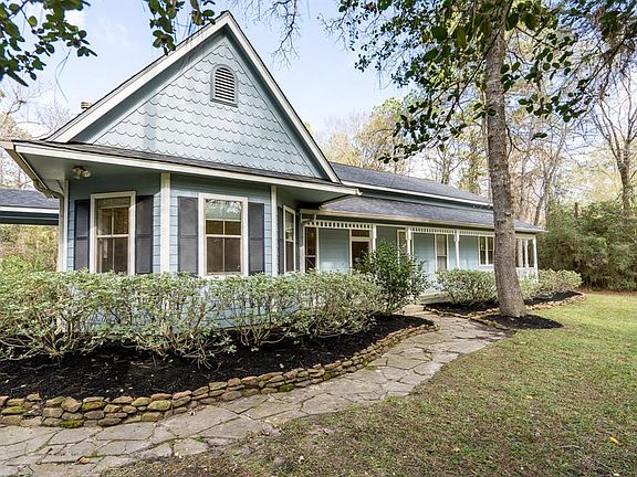 Charming victorian farmhouse feel with covered porches and flagstone paths.