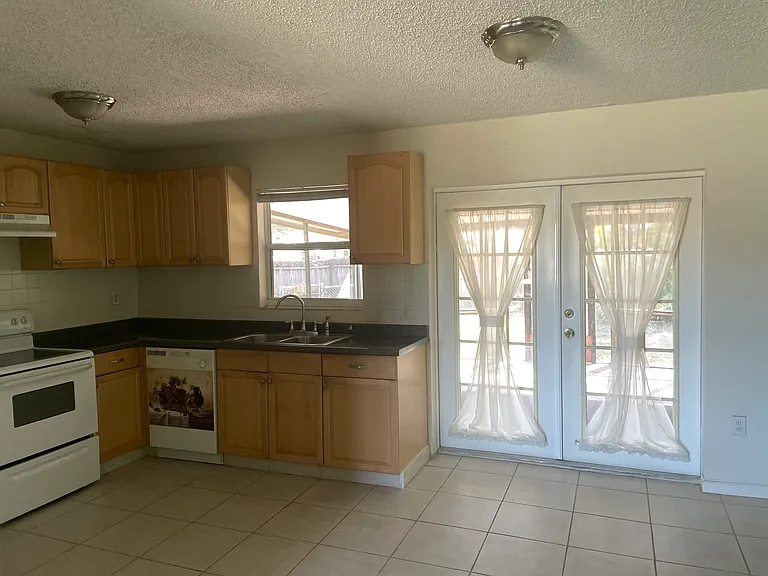 Kitchen with French doors leading to lanai