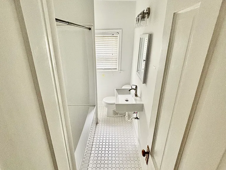 All New Full bath with ceramic tile floor, linen closet, built in space heater, large bathtub/shower combination.