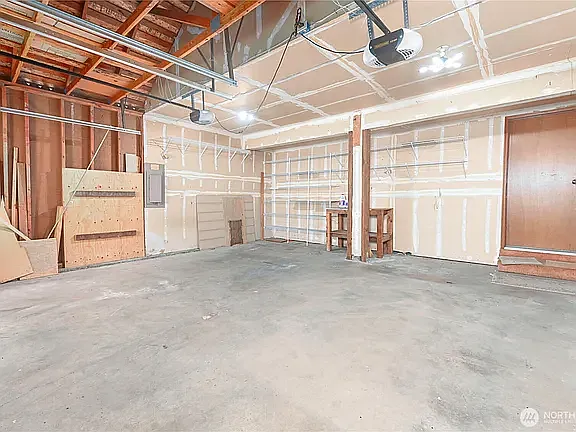 Generous attached two-car garage offering ample storage space for tools, equipment, or extra belongings.