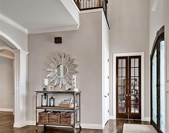 Visitors will find themselves entranced right from the beginning as they walk through this Grand, Two-story Foyer, with impressive double-doors, hardwood flooring & architectural details that set just the right mood...