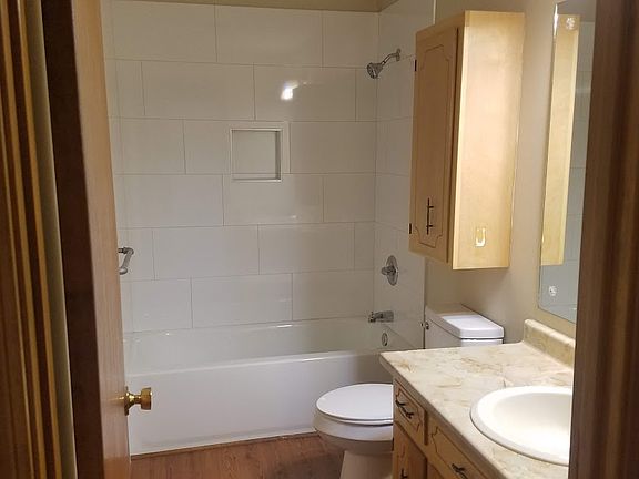 Full bathroom with new tiled shower, tub, toilet and flooring off of the living room area and between 2 bedrooms.