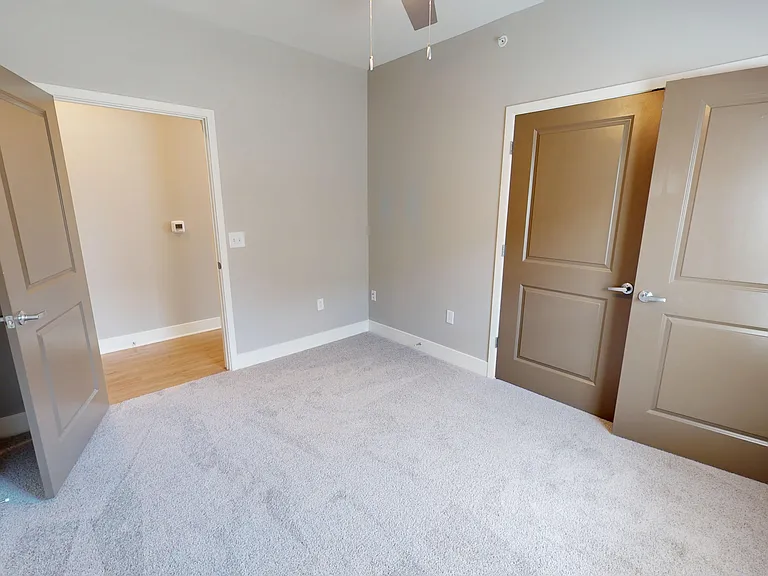The Presley floor plan's second bedroom includes soft carpet, a ceiling fan, and a large double-door closet. The Presley floor plan's second bedroom includes soft carpet, a ceiling fan, and a large double-door closet.