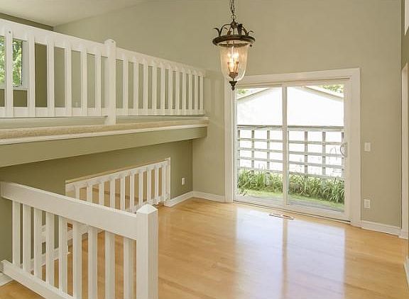 Turn to the right and see the dining room with a unique light fixture. The sliding glass doors face 
