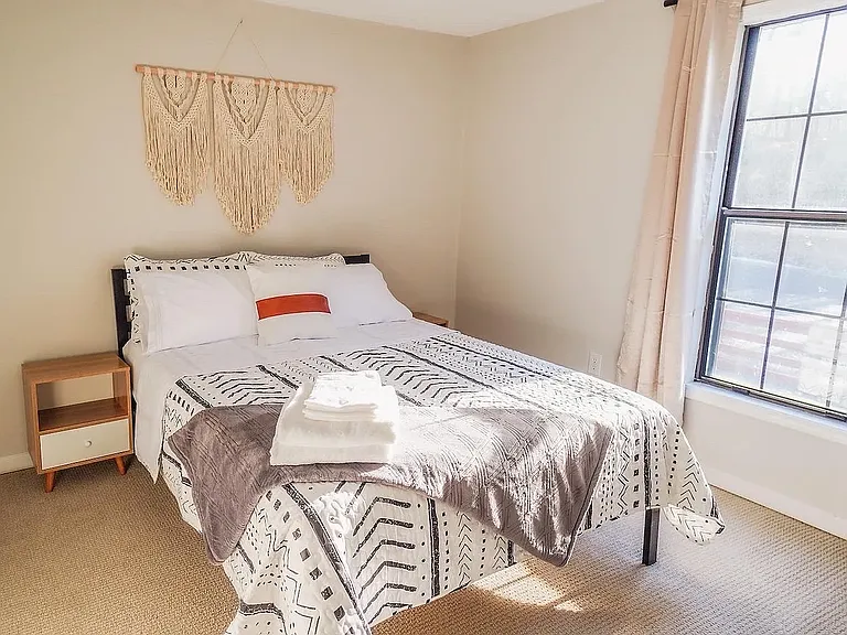 Day time photo-Private Furnished Bedroom (11x10'): Queen size bed with dresser, two nightstands, private closet, and room darkening curtains. Located on the 2nd floor along with a private full bath.