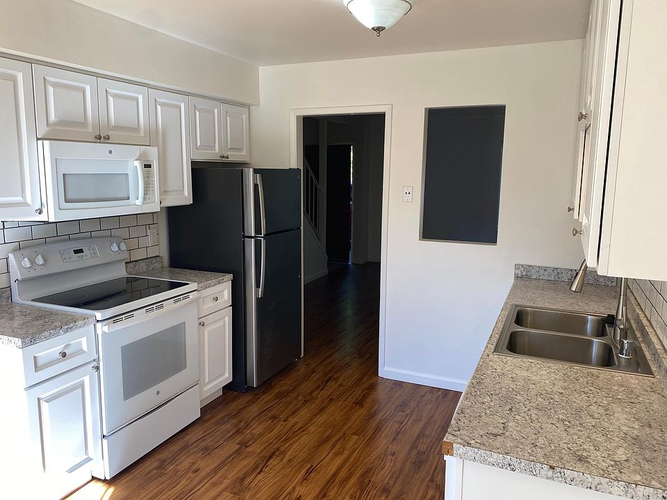 Remodeled kitchen with electric range and microwave hood.