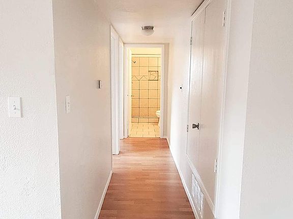 Hallway leading to bedrooms and bathroom.