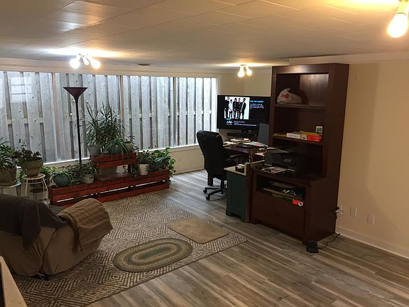 Inside additional accessory building. Furniture and personal belongings in any picture are not included. Could make great home office, Yoga/workout, or game room, etc.