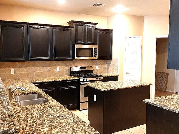 Kitchen has lots of cabinets & counter top space.