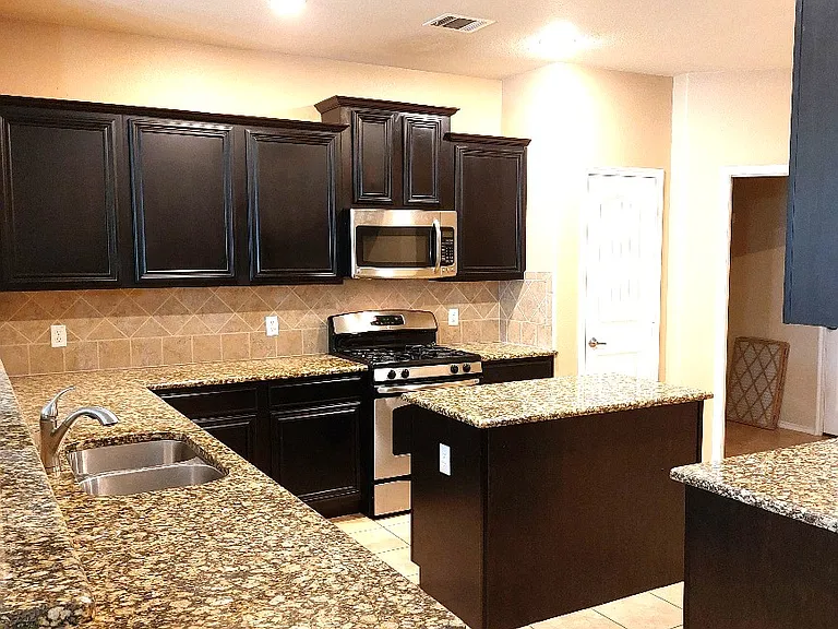 Kitchen has lots of cabinets & counter top space.