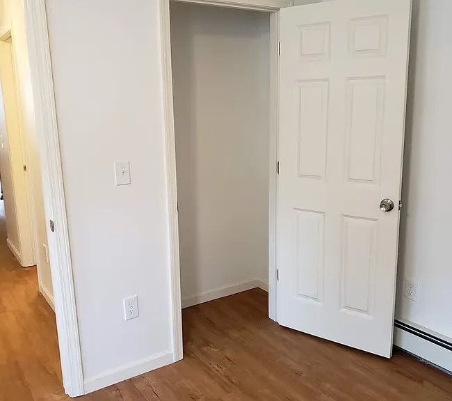 Bedroom. Measures approx 15 ft x 10 ft. Two closets. Three windows.