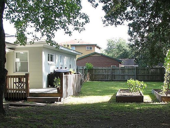 View of house, deck and garden from under the large live oak.