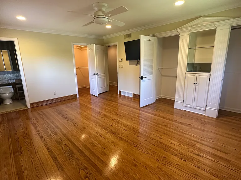 Bedroom 4, featuring two closets, built-in storage and a walk-in closet. This bedroom includes a full-bath with shower.