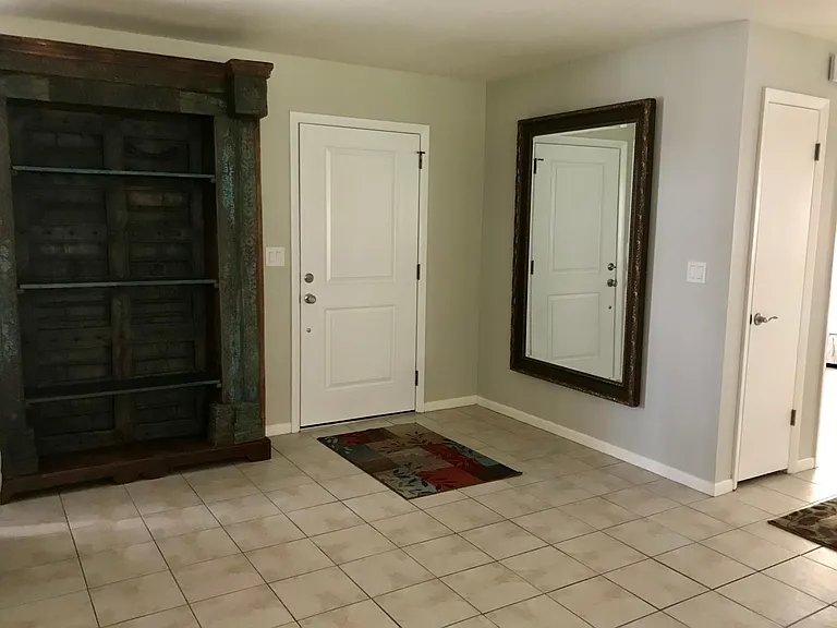 Large entry foyer with massive bookcase and mirror