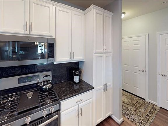 Kitchen with black granite counter tops and back splash