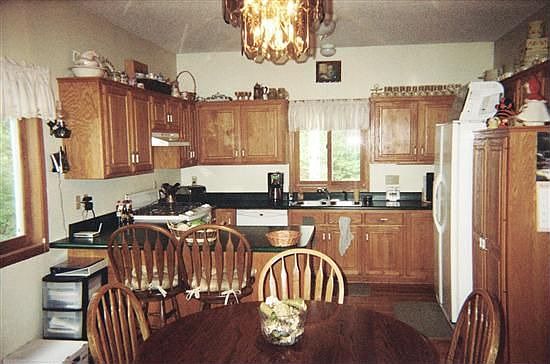 Kitchen features oak cabinets, newer appliances, and breakfast bar.