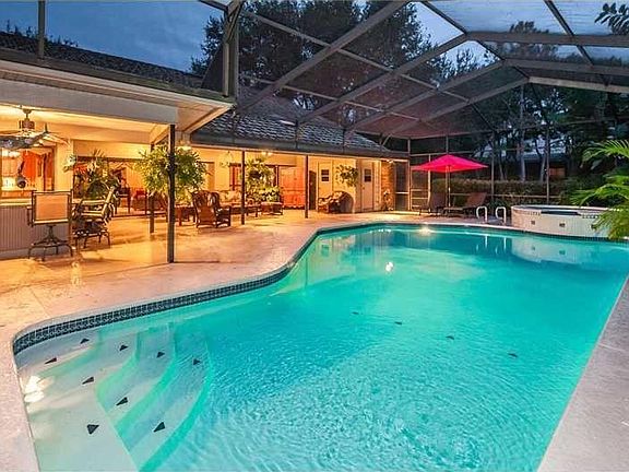 entertainer's paradise with pool, bird caged screened and covered lanai. Pool bath and outdoor kitchen