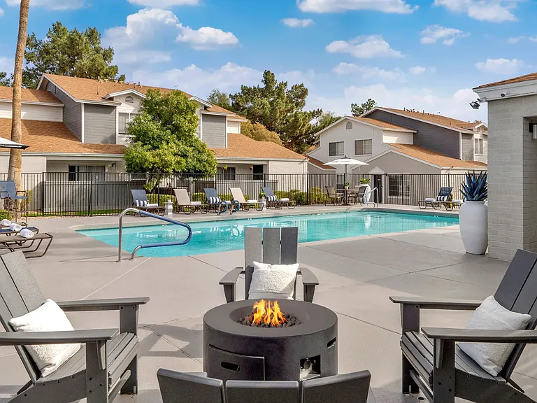 Embrace warmth and connection around our inviting poolside fire pit staged for delightful and cozy conversations day or night.