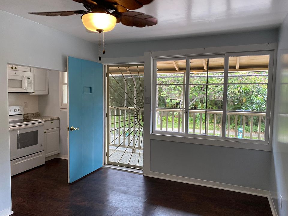 Living room with front door opens up to front balcony facing Hobron Ln.