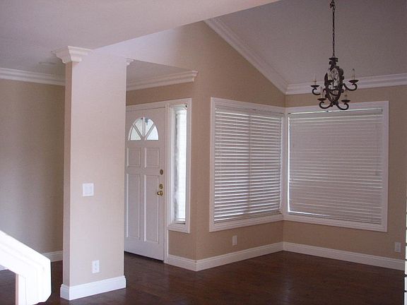 Beautiful hardwood floors, crown molding, cathedral ceiling in this lovely living room.