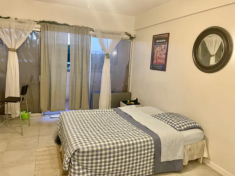 A charming room with a private balcony overlooking green parks, ideally located in sunny Central Phoenix.