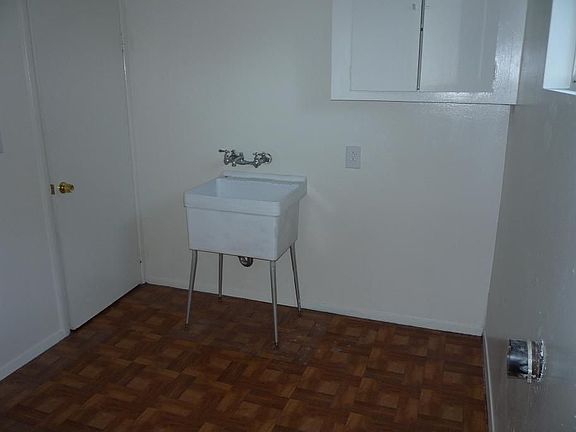 Indoor laundry with many cabinets and sink