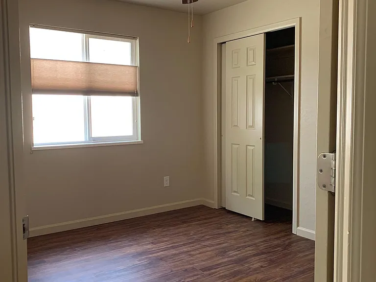 Bedroom with generous sliding-door closet, light & fan