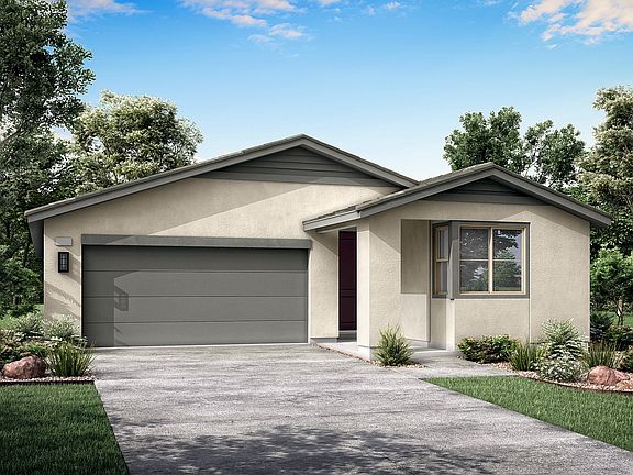 A single-story house with a gray exterior, a garage, and a paved driveway, surrounded by lush greene