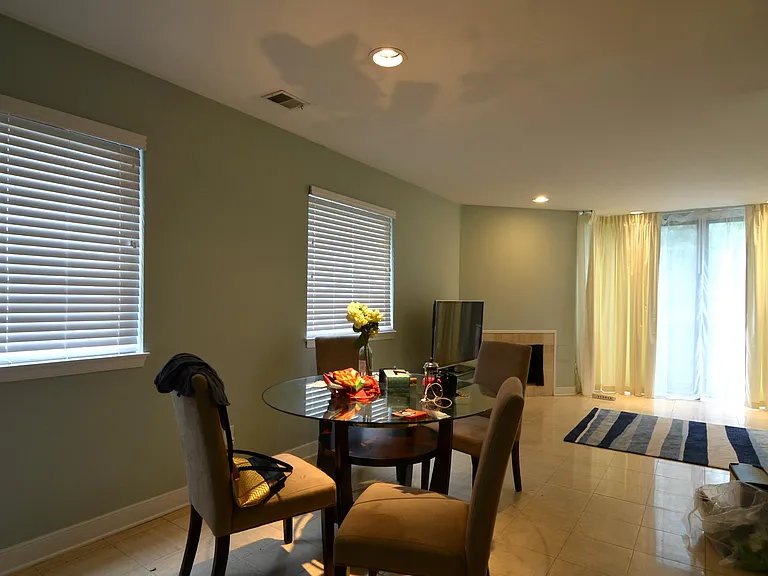 Updated kitchen with white cabinetry and stainless steel appliances