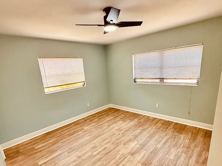 Master Bedroom that now has new curtains and double closets