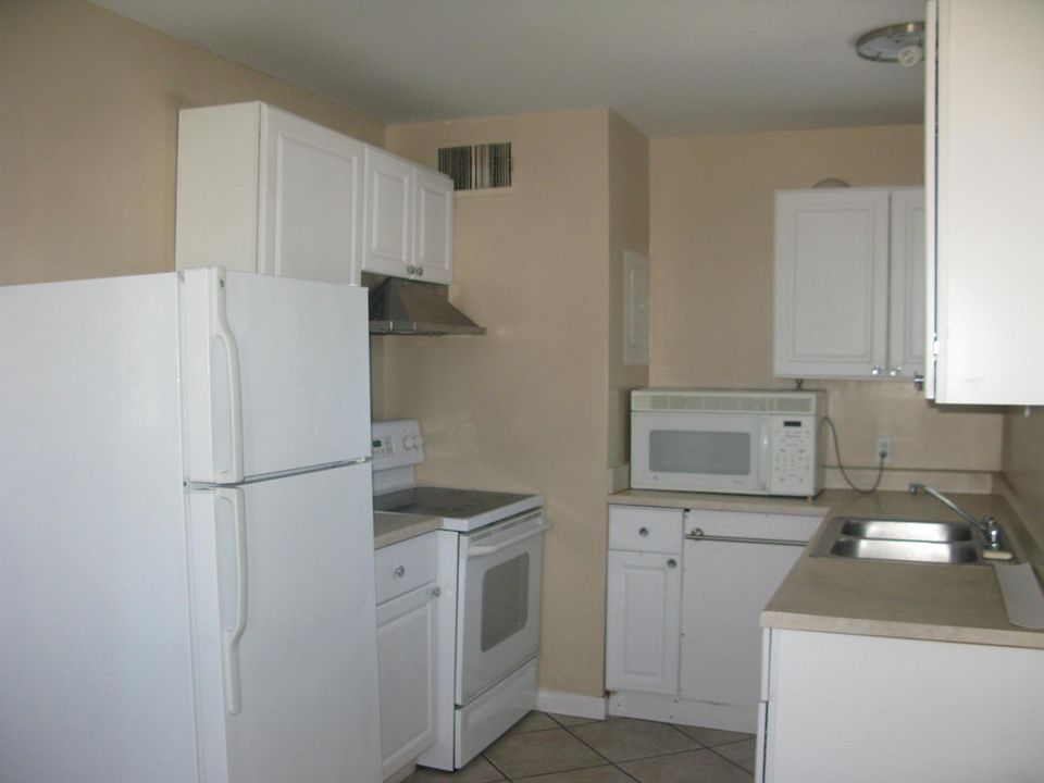 Kitchen, equipped with refrigerator, stove and microwave. Al