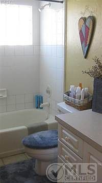 Guest bath features glass block wall.