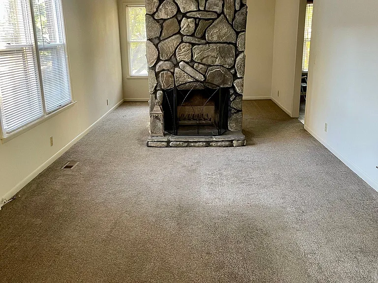 This is just a closer view of the room and fireplace. As you will notice all the windows have mini blinds to let in the natural light and to close for privacy or to darken the room to watch a movie.