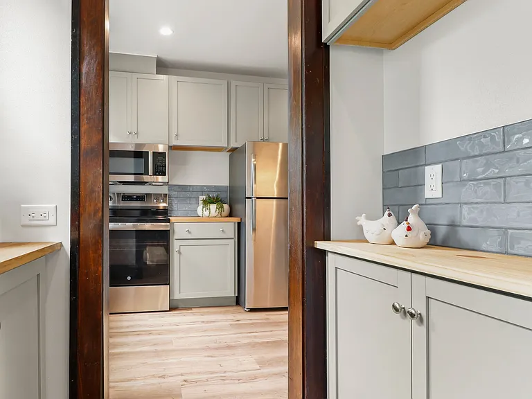 View from dining room through butler's pantry into kitchen. Downstairs unit.