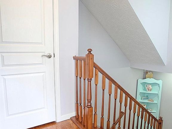 Entrance takes you down the stairs to the apartment. Door to the left is a coat/shoe rack
