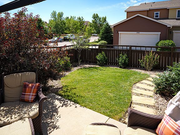 Large patio and grassy backyard with low-maintenance landscaping.
