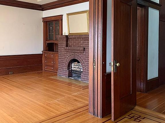Hardwood floors, original built-in cabinets, decorative fireplace (non-operable)