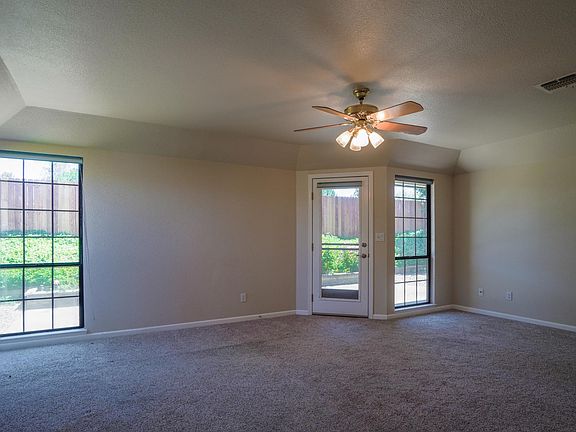 Living room with backyard seen through windows
